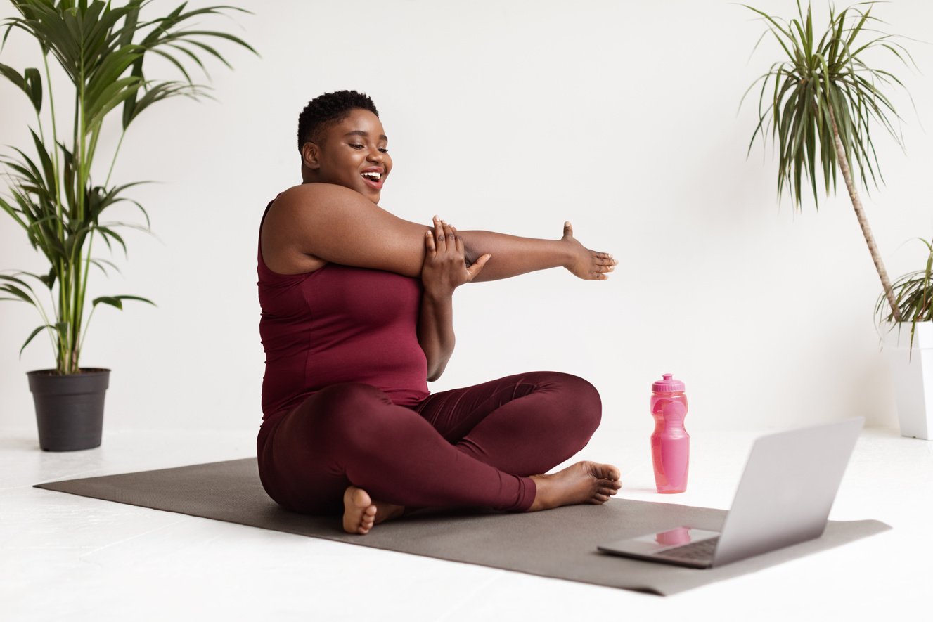 Poisitive plus Size Woman Doing Stretching in Front of Laptop